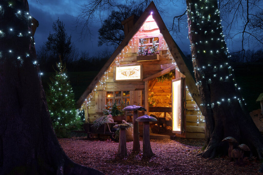 mother shiptons christmas • Little Vikings - York for Kids Santa in his cosy grotto at Mother Shipton’s Christmas Experience, surrounded by festive decorations and cheerful elves in a woodland setting