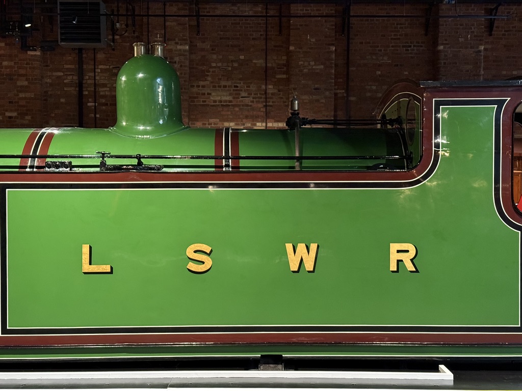 Families enjoying October half-term fun at the National Railway Museum in York — exploring restored Royal carriages in Station Hall, taking part in hands-on experiments in Wonderlab, and meeting the ghost of George Stephenson for spooky storytelling adventures.