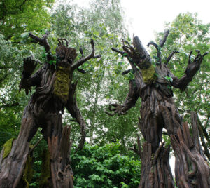Two giant tree characters towering over families in the Coppergate Centre courtyard during York BID’s Treemendous Halloween event.